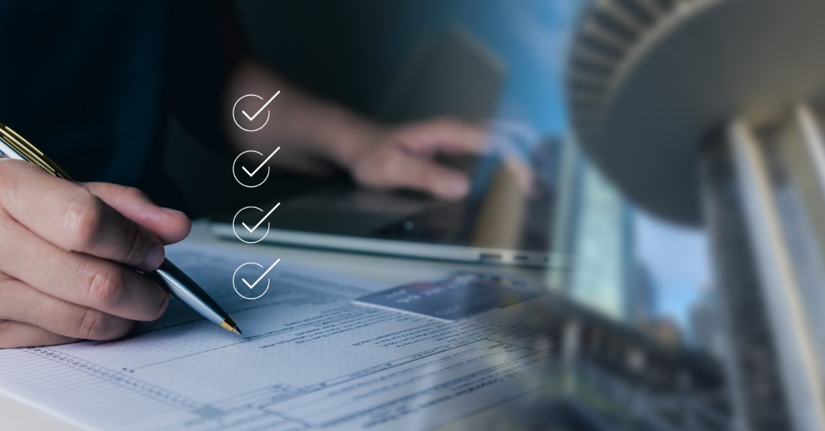 A hand using a laptop beside a credit card, a building model, and mortgage graphics across a blue background.